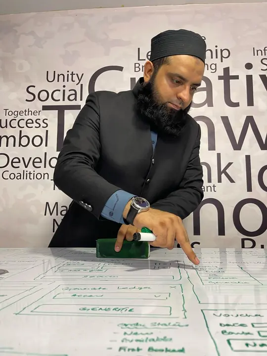 Muhammad Waqar wireframing on a whiteboard